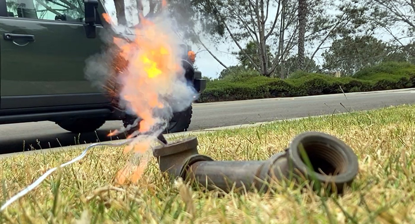 A black powder ejection test firing on a lawn