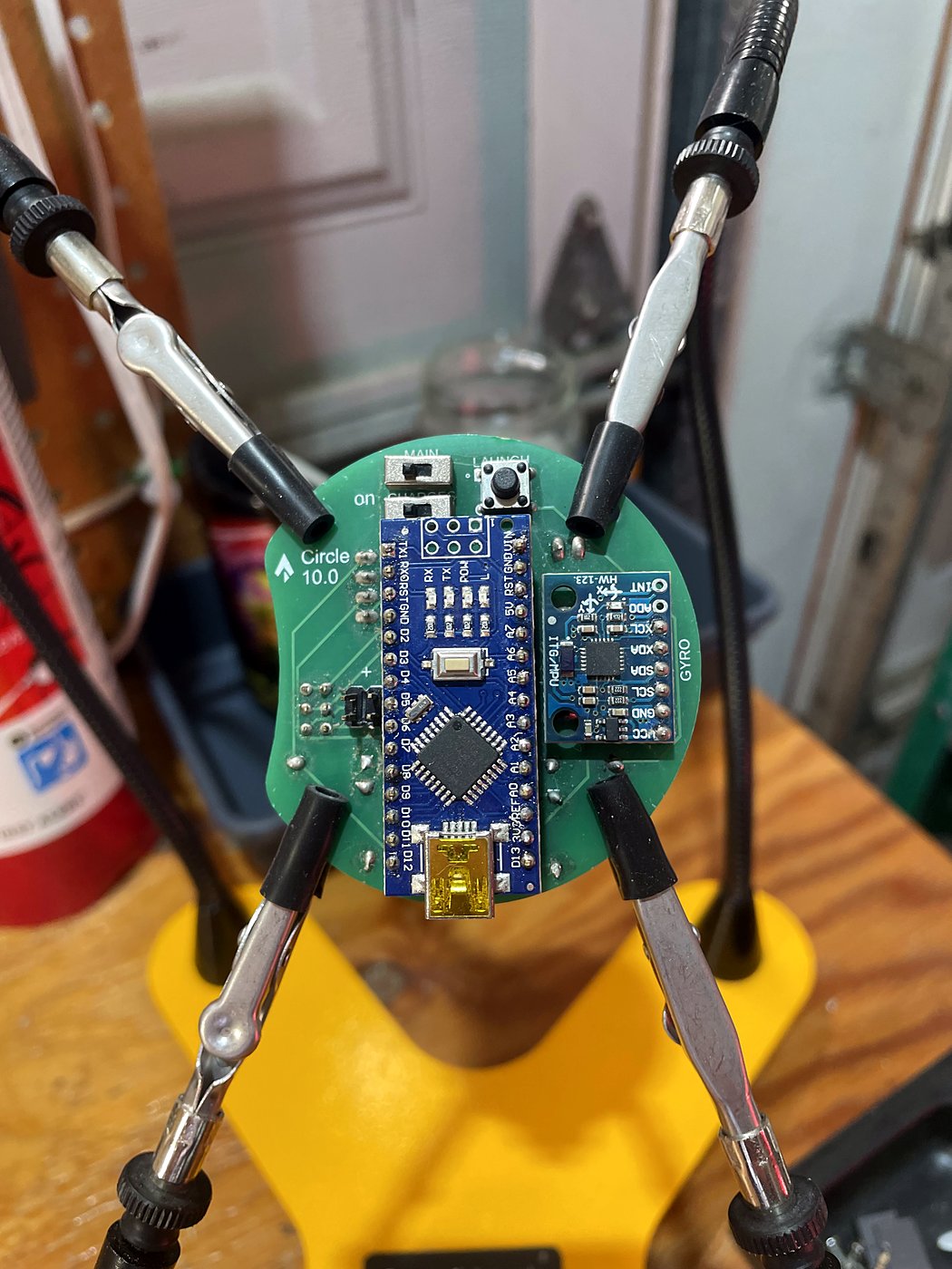 An Ares flight computer board held in helping hands