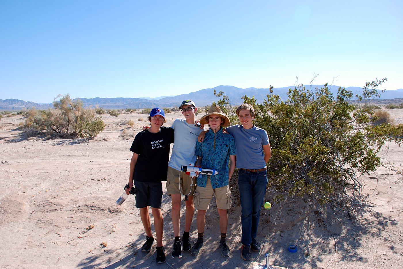 Four teenagers standing together in the desert on launch day