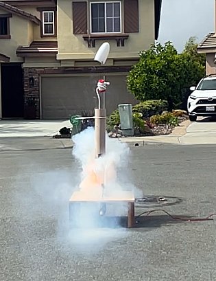 A test launch in the street, trailing smoke
