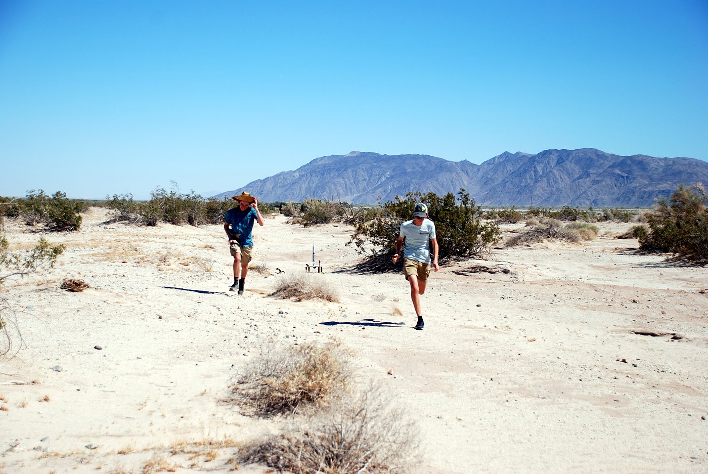 The team walking back from the launch pad across the desert
