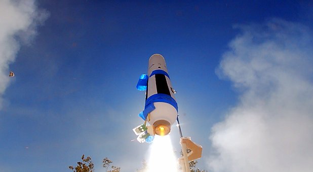 Ares climbing on its motor flame against a blue sky