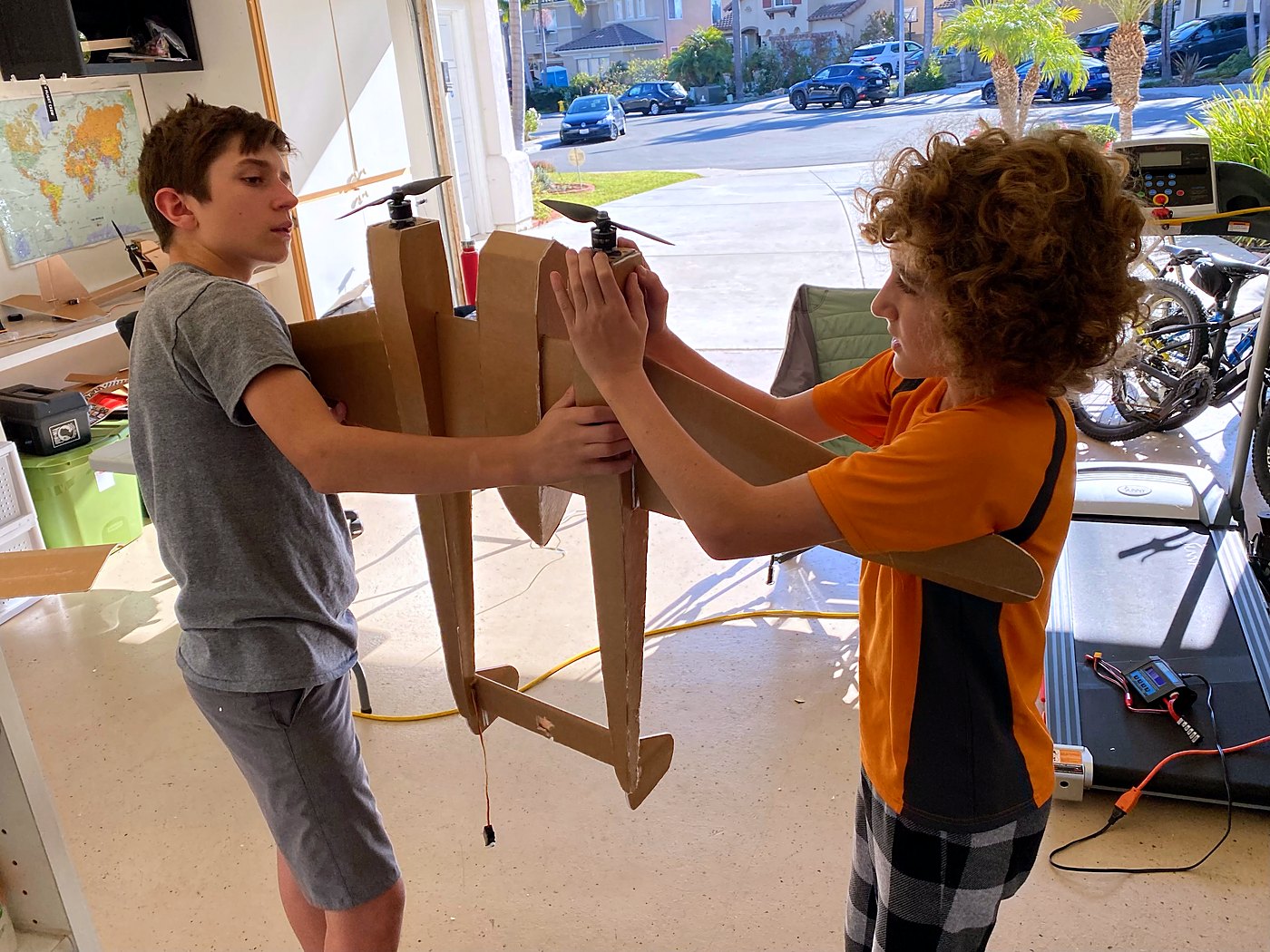 Two boys assembling the FW-189's twin booms in the garage