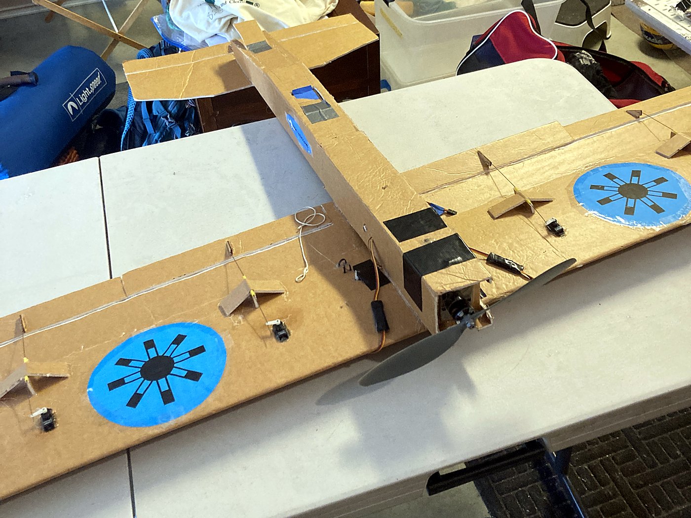 Mother Hen on a workbench with the bait-drop release mechanism mounted on top of the wing