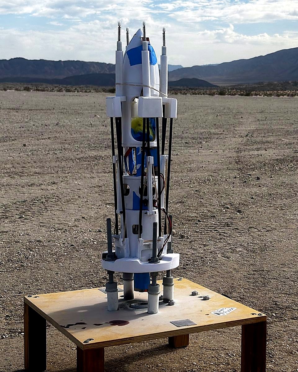 Sisyphus on its launch pad in the desert, landing legs deployed